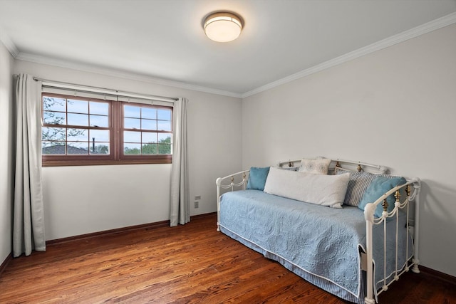bedroom featuring baseboards, ornamental molding, and wood finished floors