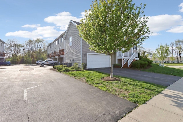 1046 Piccolo Ln, Volo, IL 60073 - view of home's exterior featuring stairway, a garage, and cooling unit