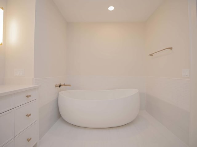 132 E Delaware Pl Unit 6205-07, Chicago, IL 60611 - full bathroom featuring vanity, a soaking tub, and wainscoting