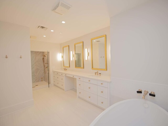 132 E Delaware Pl Unit 6205-07, Chicago, IL 60611 - bathroom with a sink, double vanity, a freestanding tub, a shower stall, and visible vents