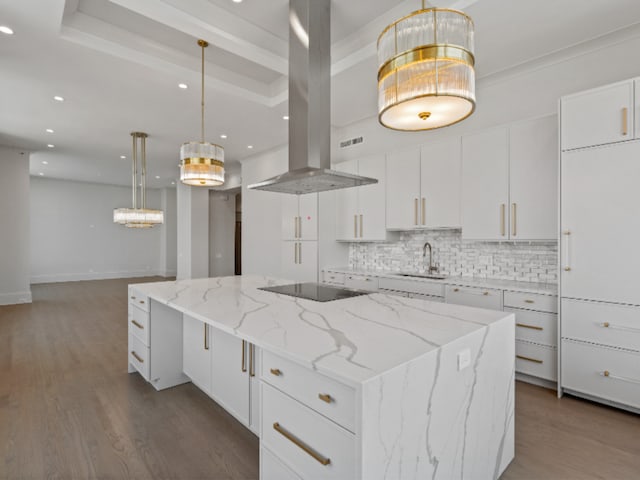 132 E Delaware Pl Unit 6205-07, Chicago, IL 60611 - kitchen featuring a large island, black electric cooktop, island exhaust hood, a sink, and backsplash