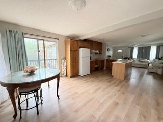 kitchen with freestanding refrigerator, light wood finished floors, and open floor plan