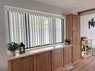 bar with radiator heating unit and light wood-style flooring