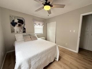 bedroom with baseboards, ceiling fan, and light wood-style flooring