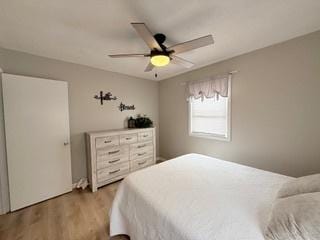 bedroom with a ceiling fan and wood finished floors