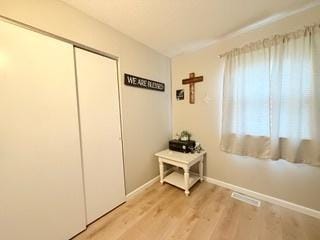 doorway with baseboards and light wood-type flooring