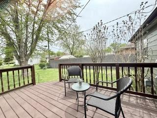 wooden deck featuring a yard