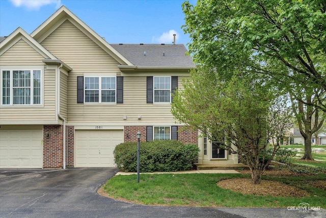 1081 Hunt Wyck Ct Unit 1081, Elgin, IL 60120 - townhome / multi-family property featuring brick siding, an attached garage, and driveway