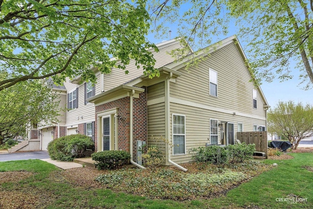 1081 Hunt Wyck Ct Unit 1081, Elgin, IL 60120 - view of property exterior featuring a garage and brick siding