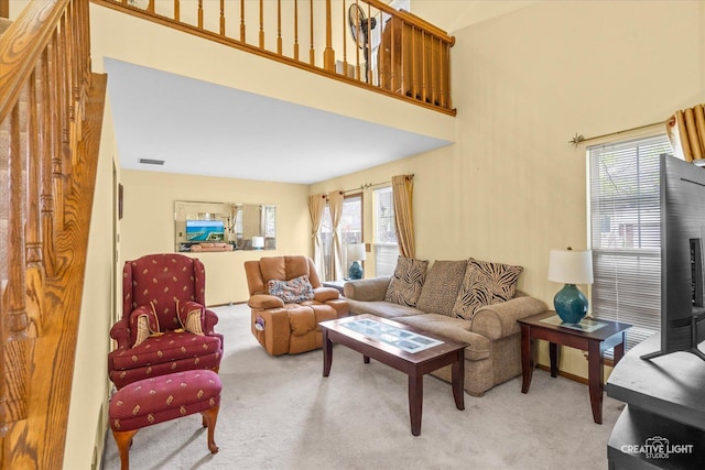 1081 Hunt Wyck Ct Unit 1081, Elgin, IL 60120 - carpeted living area with visible vents and a towering ceiling