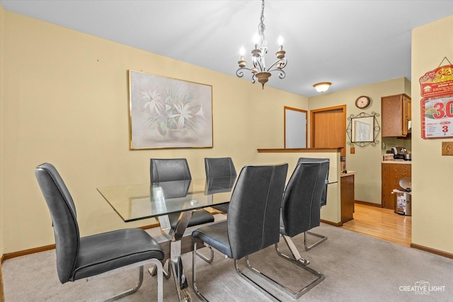 1081 Hunt Wyck Ct Unit 1081, Elgin, IL 60120 - dining space with baseboards, a notable chandelier, and light carpet