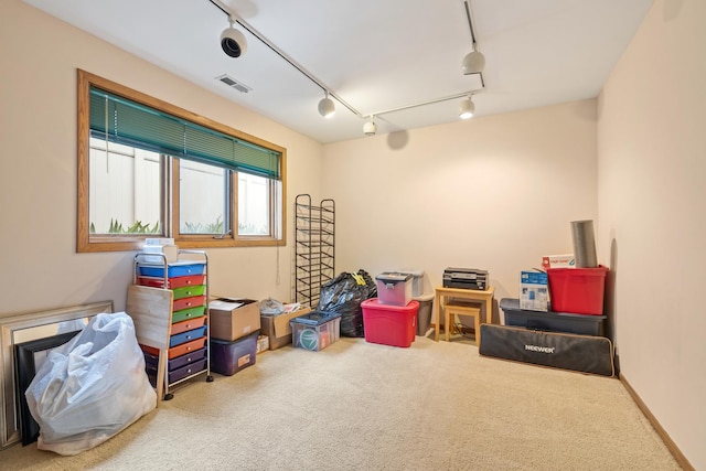 recreation room featuring carpet flooring, rail lighting, and visible vents