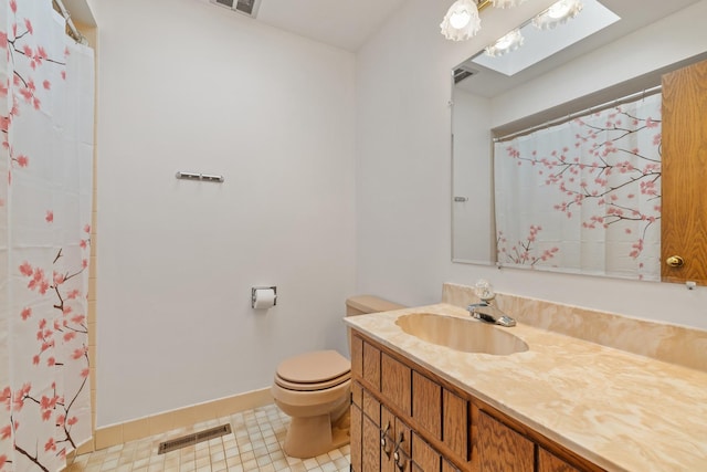 bathroom featuring vanity, baseboards, toilet, and visible vents