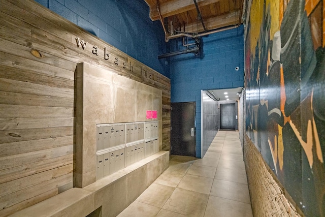 hall with tile patterned flooring and mail area