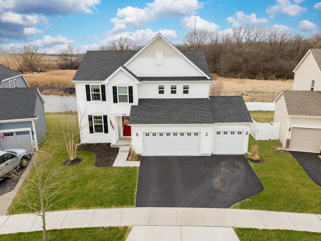 172 Barry Rd, South Elgin, IL 60177 - view of front facade with a garage, a front lawn, aphalt driveway, fence, and a shingled roof