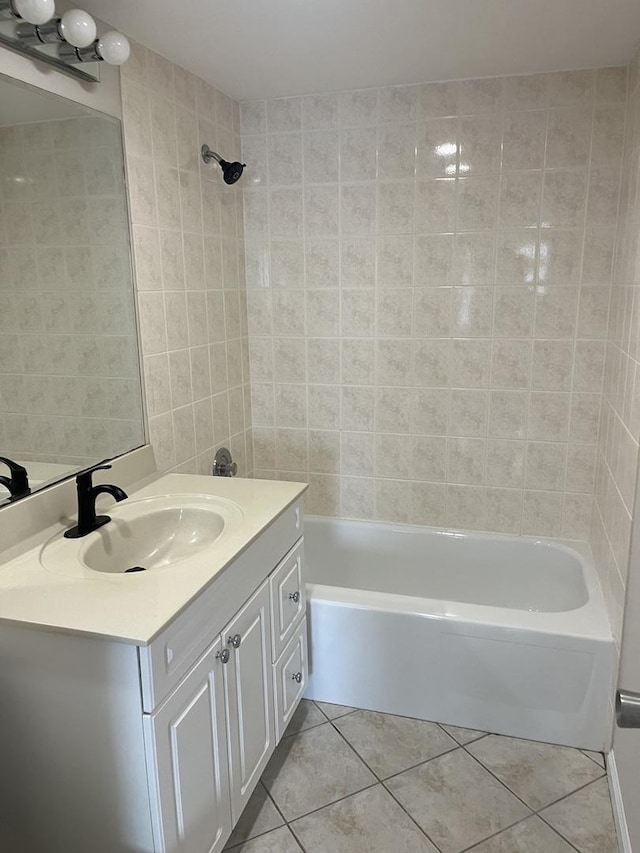 full bathroom featuring tile patterned floors, tile walls, tub / shower combination, and vanity