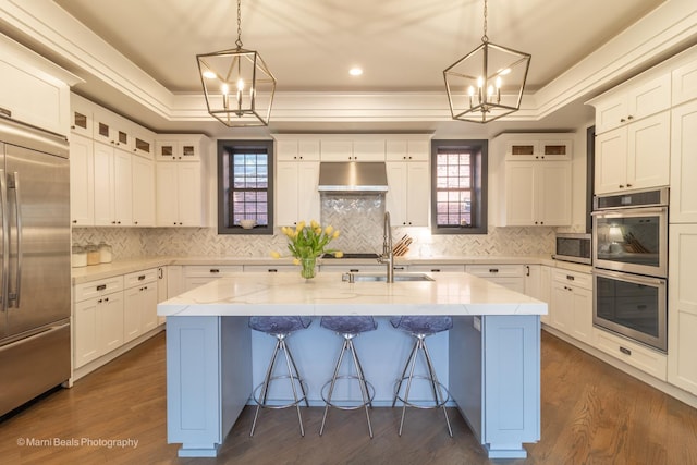 6907 S Constance Ave, Chicago, IL 60649 - kitchen with a kitchen breakfast bar, a center island with sink, white cabinets, appliances with stainless steel finishes, and a notable chandelier