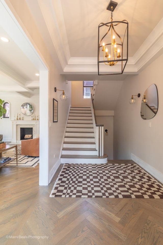 6907 S Constance Ave, Chicago, IL 60649 - entryway with baseboards, a tray ceiling, and a chandelier