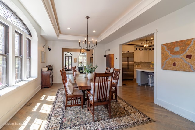 6907 S Constance Ave, Chicago, IL 60649 - dining area with light wood-style floors, a chandelier, recessed lighting, baseboards, and a tray ceiling
