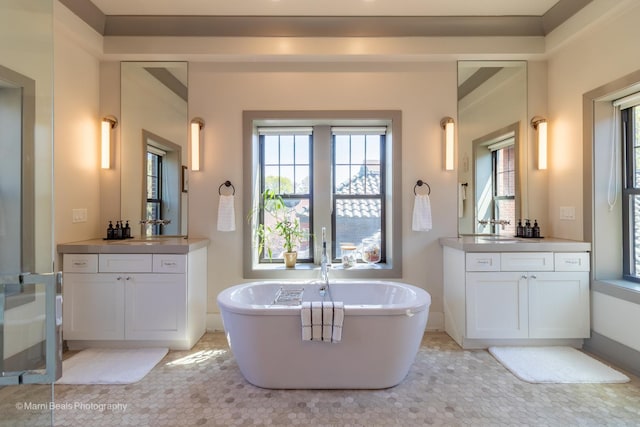 6907 S Constance Ave, Chicago, IL 60649 - full bathroom with baseboards, a sink, two vanities, and a soaking tub