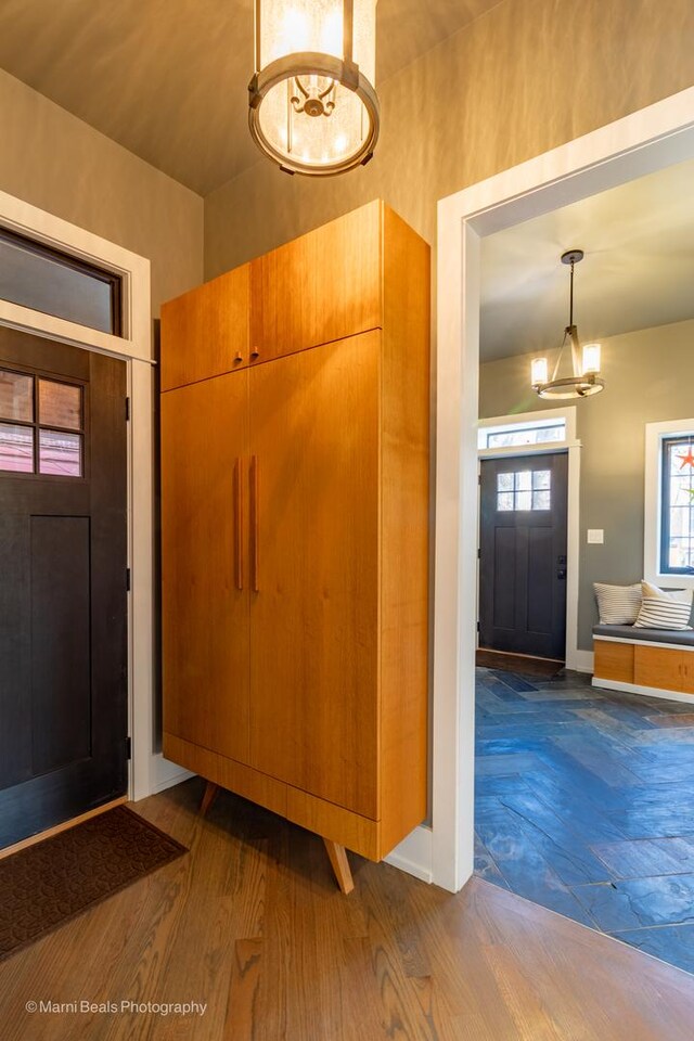 6907 S Constance Ave, Chicago, IL 60649 - entryway with baseboards, dark wood-style flooring, and a chandelier