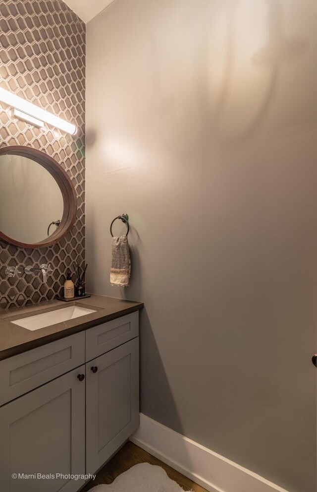 6907 S Constance Ave, Chicago, IL 60649 - bathroom featuring vanity, baseboards, and backsplash