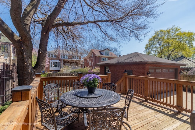 6907 S Constance Ave, Chicago, IL 60649 - deck featuring fence, outdoor dining space, and an attached garage