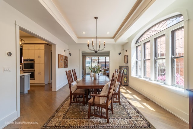 6907 S Constance Ave, Chicago, IL 60649 - dining room with baseboards, recessed lighting, a tray ceiling, a chandelier, and light wood-style flooring