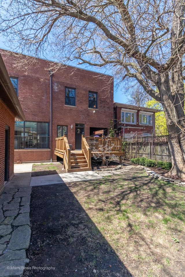 6907 S Constance Ave, Chicago, IL 60649 - rear view of house featuring brick siding, fence, and a deck