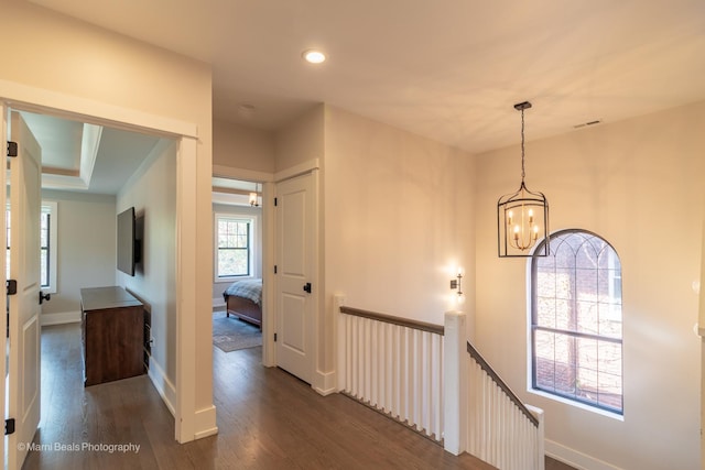 6907 S Constance Ave, Chicago, IL 60649 - hall featuring baseboards, dark wood-type flooring, recessed lighting, a chandelier, and an upstairs landing