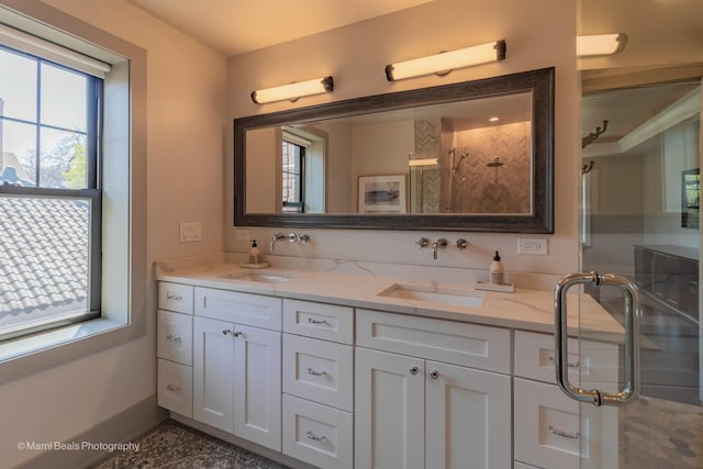 6907 S Constance Ave, Chicago, IL 60649 - bathroom with double vanity, baseboards, a sink, and a stall shower