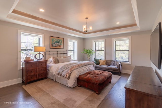 6907 S Constance Ave, Chicago, IL 60649 - bedroom with an inviting chandelier, a raised ceiling, wood finished floors, and multiple windows