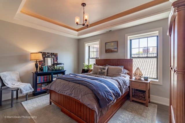 6907 S Constance Ave, Chicago, IL 60649 - bedroom featuring a tray ceiling, a notable chandelier, wood finished floors, and visible vents