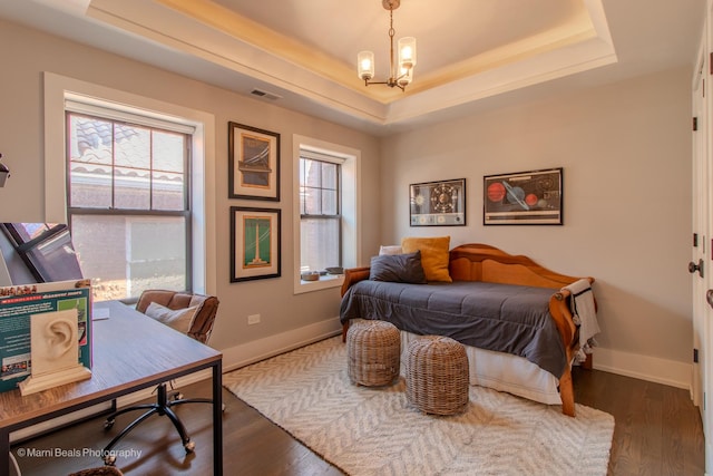 6907 S Constance Ave, Chicago, IL 60649 - bedroom with visible vents, wood finished floors, baseboards, a raised ceiling, and a chandelier