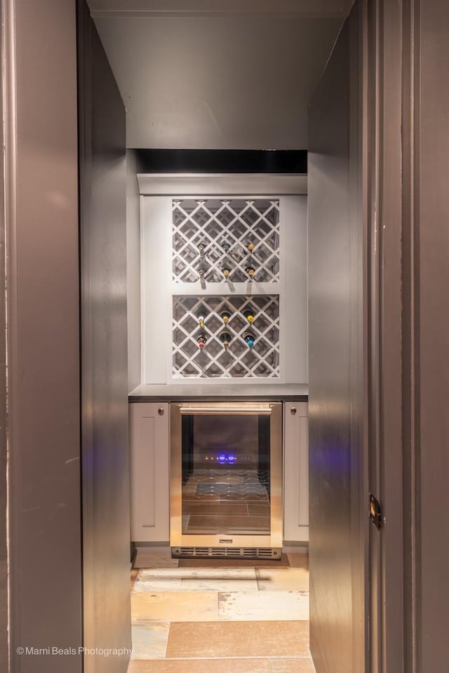 6907 S Constance Ave, Chicago, IL 60649 - wine area with light wood-style flooring and beverage cooler