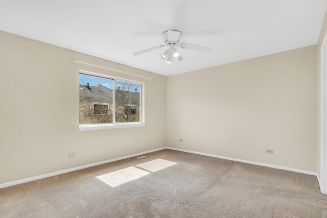 empty room featuring carpet floors, baseboards, and a ceiling fan