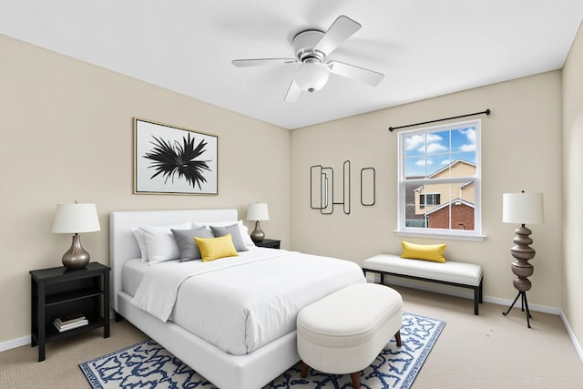 carpeted bedroom featuring baseboards and a ceiling fan