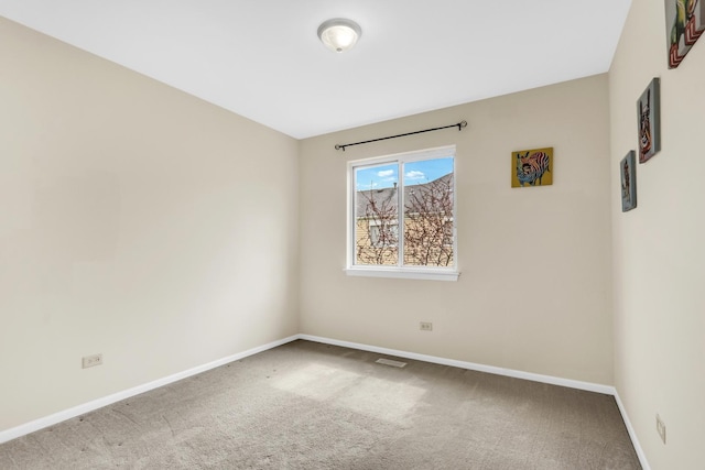 carpeted spare room with baseboards and visible vents