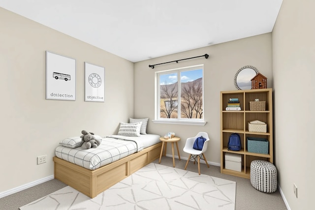 bedroom with baseboards and carpet