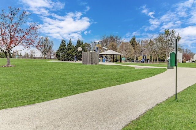 view of property's community featuring a gazebo, playground community, a yard, and community basketball court