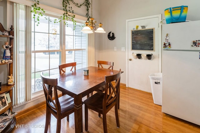2048 Navarone Dr, Naperville, IL 60565 - dining area featuring a chandelier, light wood-style flooring, and a healthy amount of sunlight