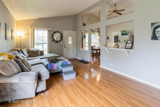 2048 Navarone Dr, Naperville, IL 60565 - living room with baseboards, wood finished floors, a ceiling fan, and high vaulted ceiling