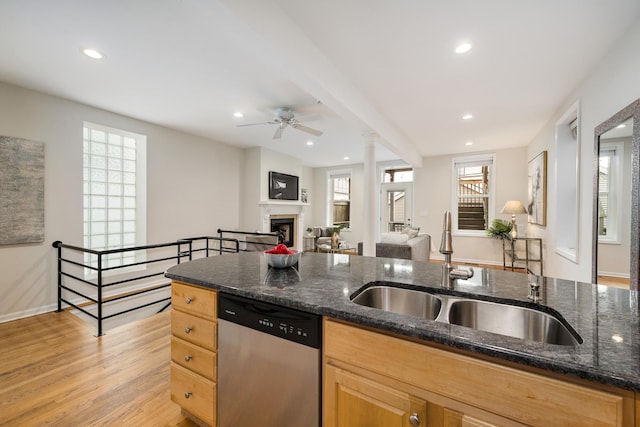 kitchen featuring ceiling fan, a sink, a fireplace, dishwasher, and open floor plan
