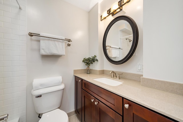 bathroom with vanity, walk in shower, and toilet