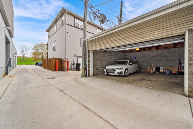 view of side of home featuring driveway and a garage