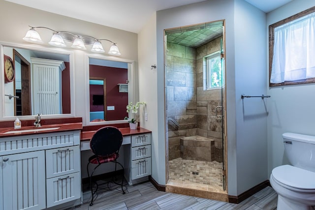 11 N Beech St, Princeton, IL 61356 - full bathroom with toilet, a stall shower, wood finish floors, vanity, and baseboards