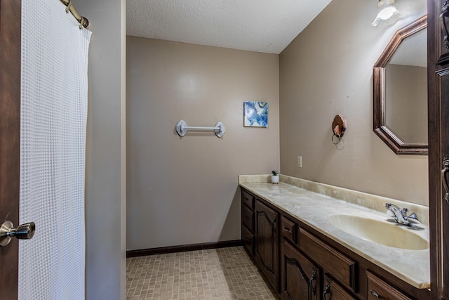 11 N Beech St, Princeton, IL 61356 - bathroom with vanity, baseboards, a textured ceiling, and a shower with shower curtain