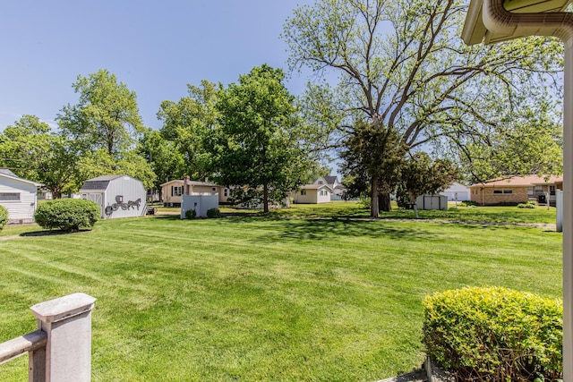 11 N Beech St, Princeton, IL 61356 - view of green lawn featuring a storage unit, an outbuilding, and a residential view