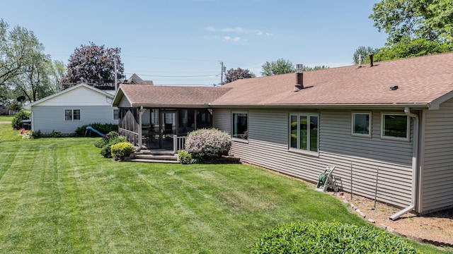11 N Beech St, Princeton, IL 61356 - back of house featuring a sunroom, a yard, and a shingled roof