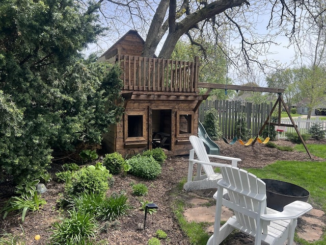 view of jungle gym featuring fence